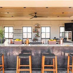 Tetto Rooftop Bar - The modern bar setup at Tetto, framed by natural light, wood accents, and an inviting mix of rustic elegance and wine country...
