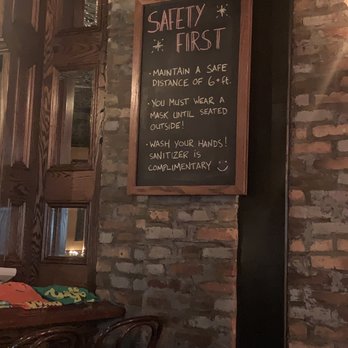 Golden Years - a brick wall with a chalkboard saying safety first - Gastropubs Near Me - Brooklyn, New York