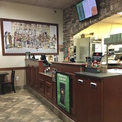 Marco's Pizza - Counter with history of Marco's Pizza on the wall.