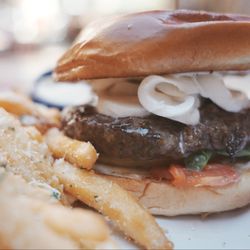 Mission Inn Restaurant - Spring Caprese Burger. A juicy patty topped with fresh mozzarella slices, spinach/basil, and ripe tomato.