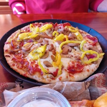 Roosters Circleville - a pizza with peppers and onions - Chicken Wings Near Me - Circleville, Ohio