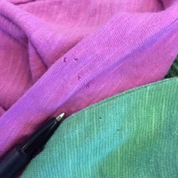 Family Thrift Center - Photo of the holes that their staples put in clothing.