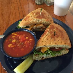 Spicy chicken grilled sandwich on focaccia and cup of vegetable soup Spicy chicken grilled sandwich on focaccia and cup of vegetable soup