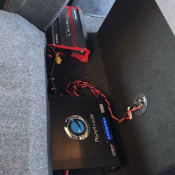 One Stop Custom Shop - Top: 2000W 4 channel Crunch amp for speakers in the cabin and a 1500W Planet Audio Anarchy monoblock amp for the subs.