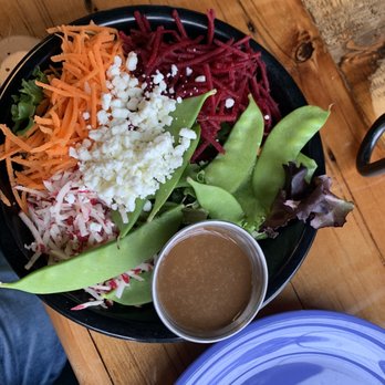 Folino's Pizza - a bowl of salad with dressing - Pizza Near Me - Burlington, Vermont