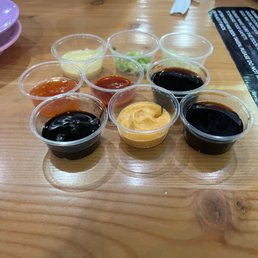 All the sauce/topping options on the self-serve bar. All the sauce/topping options on the self-serve bar.