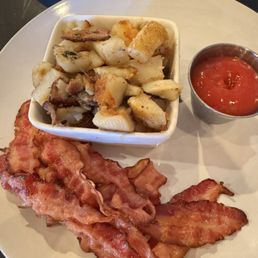 Breakfast potatoes and a generous side of bacon Breakfast potatoes and a generous side of bacon