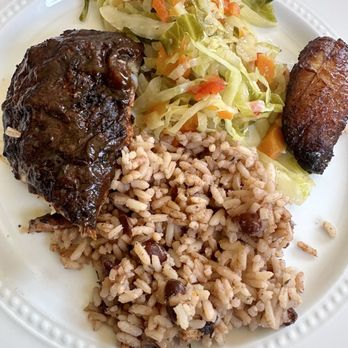 Island Vibes - A portion of my jerk chicken to-go meal, plated at home. With rice/beans, stewed cabbage and plantains. So delish! - Caribbean Near Me - Nashville, Tennessee