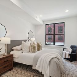The Anchorage on Kelly - A bedroom with a large bed and a large window