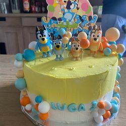 FLOUR MOON BAKERY - Bluey themed birthday cake, the three holes was where the candles were