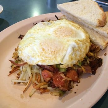 Pork Store Cafe - Eggs in a Nest: two eggs on a bed of hash browns, bacon, bell pepper, tomatoes, cheese, onion, and garlic - Breakfast & Brunch Near Me - San Francisco, California Pork Store Cafe - Eggs in a Nest: two eggs on a bed of hash browns, bacon, bell pepper, tomatoes, cheese, onion, and garlic - Breakfast & Brunch Near Me - San Francisco, California