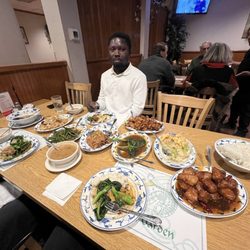 Hunan Garden - Owusu from Ghana enjoying his first Chinese Christmas dinner