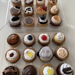 a variety of cupcakes in a plastic container a variety of cupcakes in a plastic container