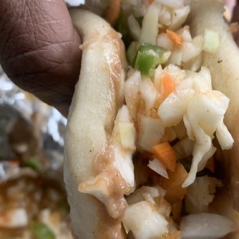 Pollo Amigo - a person holding a hot dog - Peruvian Near Me - Towson, Maryland