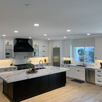 Willard Woodworks - a kitchen with white cabinets and a black island - General Contractors Near Me - Norco, California Willard Woodworks - a kitchen with white cabinets and a black island - General Contractors Near Me - Norco, California