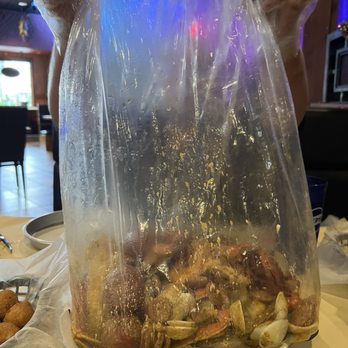 Crafty Crab - Boil bag arriving at table - Seafood Near Me - Altamonte Springs, Florida Crafty Crab - Boil bag arriving at table - Seafood Near Me - Altamonte Springs, Florida
