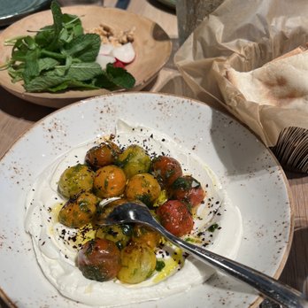 Rumi's Kitchen - Colony Square - Labne Charred Tomato $13- basil purée, Urfa chili, lemon salt - Persian/Iranian Near Me - Atlanta, Georgia Rumi's Kitchen - Colony Square - Labne Charred Tomato $13- basil purée, Urfa chili, lemon salt - Persian/Iranian Near Me - Atlanta, Georgia