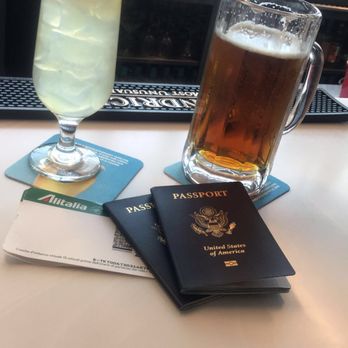 Taste NY - a glass of beer and a passport on a table - Grocery Near Me - Jamaica, New York Taste NY - a glass of beer and a passport on a table - Grocery Near Me - Jamaica, New York