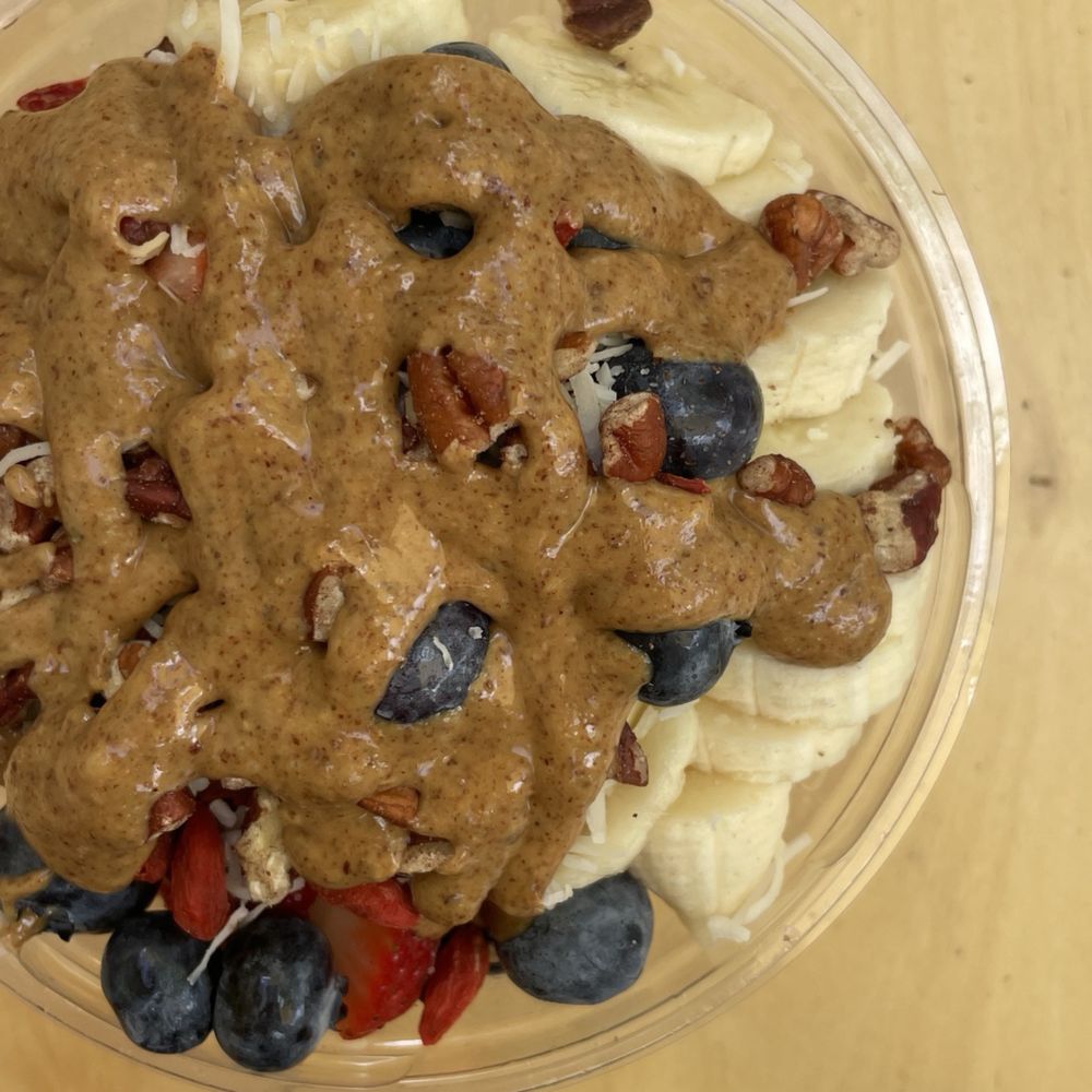 Asai bowl with banana, blueberry, strawberry, nuts, coconut and almond butter. Asai bowl with banana, blueberry, strawberry, nuts, coconut and almond butter.