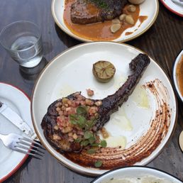 Smoked Tomahawk pork chop and grilled Australian ribeye