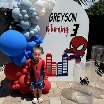 Busy Mama Events - A wall and balloon garland made from Melissa - Bounce House Rentals Near Me