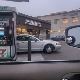 a silver car at a gas station