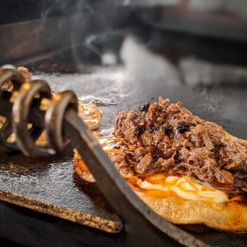 Quick Fix Cuisine - Birria tacos on the comal soaking up that in house chili oil - Food Trucks Near Me - San Marcos, Texas