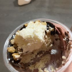 The Cake Fairy - Two layers of a cake, chocolate mousse, topped with chocolate sauce, walnuts, and whip.