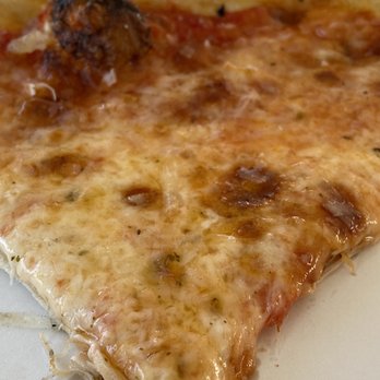 Fusion Street Food - a slice of pizza on a paper plate - Food Trucks Near Me - Tupper Lake, New York Fusion Street Food - a slice of pizza on a paper plate - Food Trucks Near Me - Tupper Lake, New York