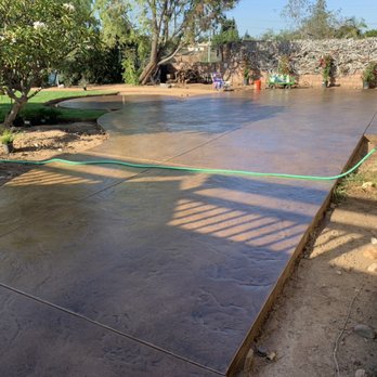 Good Grounds Landscaping - Stamped and stain concrete patio with fire pit circle - Landscaping Near Me Good Grounds Landscaping - Stamped and stain concrete patio with fire pit circle - Landscaping Near Me