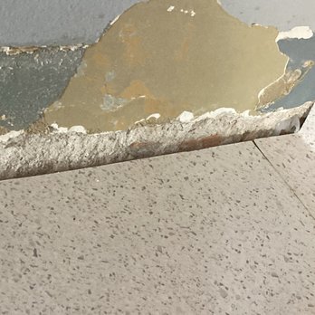 Zakha - Damaged cement wall where old countertop was removed - Handyman Near Me