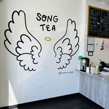 Song Tea & Poke - two wings drawn on the wall - Poke Near Me - Savage, Minnesota Song Tea & Poke - two wings drawn on the wall - Poke Near Me - Savage, Minnesota