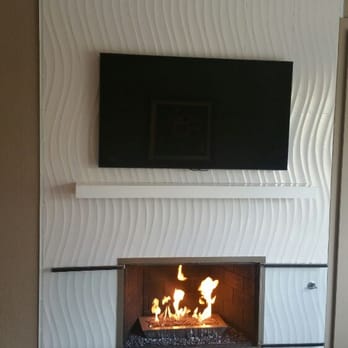 Abrew Construction - a fireplace with a flat screen tv above it - General Contractors Near Me - Pleasanton, California