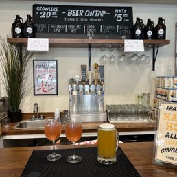 two glasses of beer on a bar