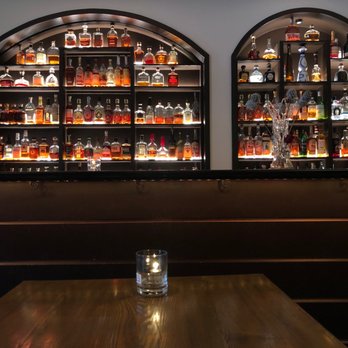 ROC Restaurant - a table with a glass of water in front of a wall of liquor bottles - Italian Near Me - Louisville, Kentucky ROC Restaurant - a table with a glass of water in front of a wall of liquor bottles - Italian Near Me - Louisville, Kentucky