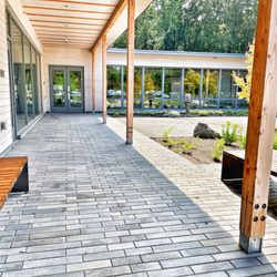 Norwell Public Library - Covered entranceway with benches and garden