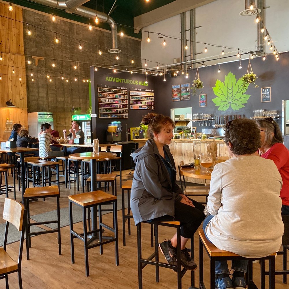 Devil's Club Brewing - a group of people sitting at tables - Brewpubs Near Me - Juneau, Alaska Devil's Club Brewing - a group of people sitting at tables - Brewpubs Near Me - Juneau, Alaska