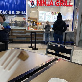 Ninja Grill - a person eating a piece of pizza - Japanese Near Me - Cincinnati, Ohio