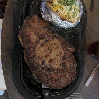 Spices On The Green - 16 oz rib eye black and blue with loaded baked potato - Steakhouses Near Me - Burlington, Colorado