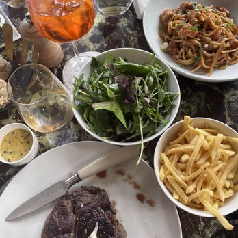 CoCo - Beef sirloin, fries, salad, and Aperol spritz. Also featured is the creamy linguini - French Near Me - Paris, 01 CoCo - Beef sirloin, fries, salad, and Aperol spritz. Also featured is the creamy linguini - French Near Me - Paris, 01