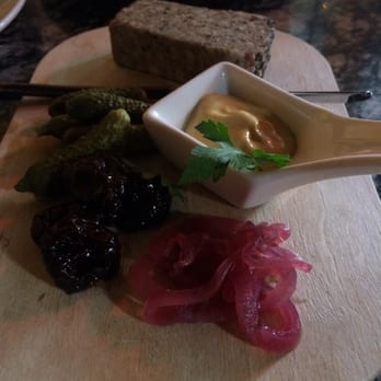 The Sitting Room - Pepper crusted pate with a side of cornichons, pickled onion, mustard, and pickled cherries (?). Served with pieces of bread. - Wine Bars Near Me - Seattle, Washington