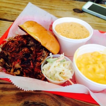Eli's BBQ - Riverside - Pulled pork sandwich with Mac and cheese and jalapeño cheddar grits. - Barbeque Near Me - Cincinnati, Ohio Eli's BBQ - Riverside - Pulled pork sandwich with Mac and cheese and jalapeño cheddar grits. - Barbeque Near Me - Cincinnati, Ohio
