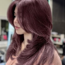 Medium layered haircut with face framing curtain bangs