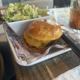 PB and J burger with a Cesar salad. PB and J burger with a Cesar salad.