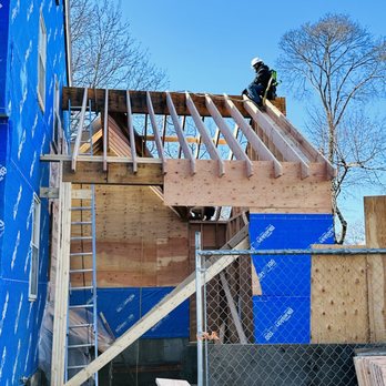 Ds Empire General Construction - a man on a roof - Refinishing Services Near Me