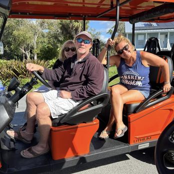 Rent Gulf Carts - The new 6-seater golf cart in orange with friends. - Golf Cart Rentals Near Me Rent Gulf Carts - The new 6-seater golf cart in orange with friends. - Golf Cart Rentals Near Me