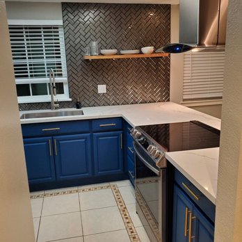 Reynoza Remodeling - a kitchen with blue cabinets - General Contractors Near Me Reynoza Remodeling - a kitchen with blue cabinets - General Contractors Near Me