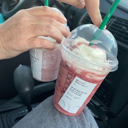 a hand holding a cup of coffee a hand holding a cup of coffee