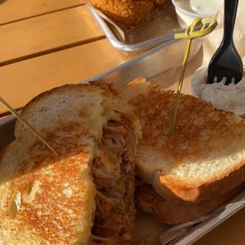 American Grub - Pulled pork grilled cheese sandwich and potato salad. Onion rings with Parmesan cheese. - Burgers Near Me - Tustin, California