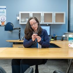 HearWell Center - Dr. Yoder checks a hearing aid